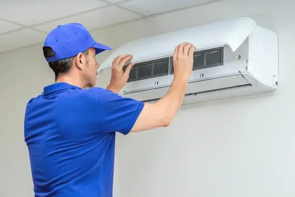 AC Repair Technician fixing an outdoor unit